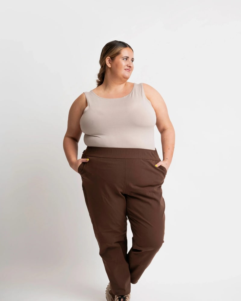 Front of a model wearing a size 6X open air pant (28") in mocha by alder apparel. | dia_product_style_image_id:319017